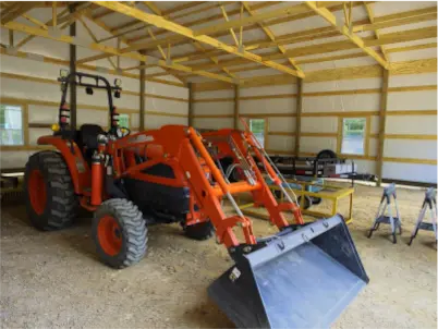 Amish Pole Barn Construction in Salem, NJ - Rossbrook Construction Tractor inside of a barn.